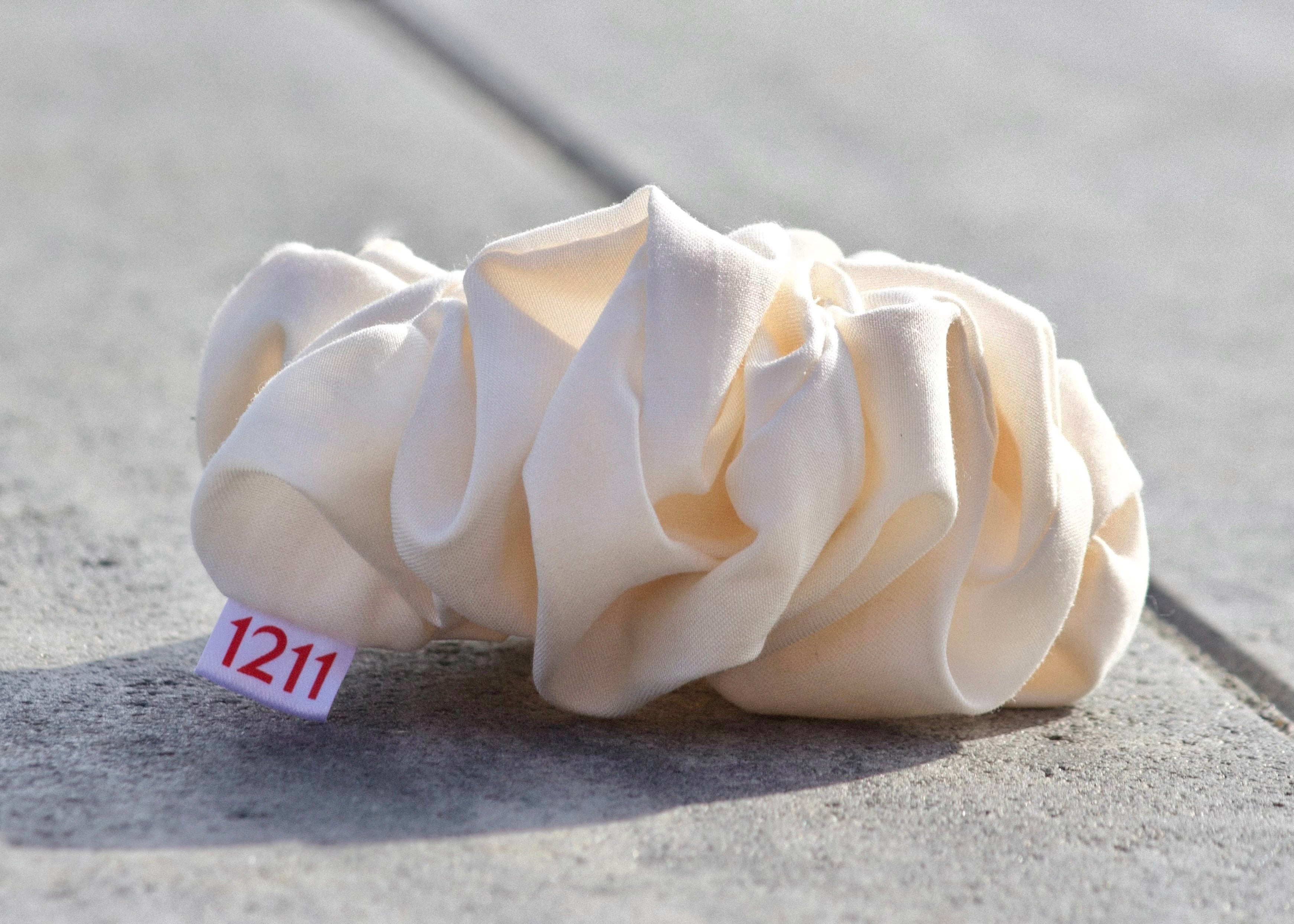 White scrunchie, elegant hair accessory from Twelveeleven, perfect for everyday styling.