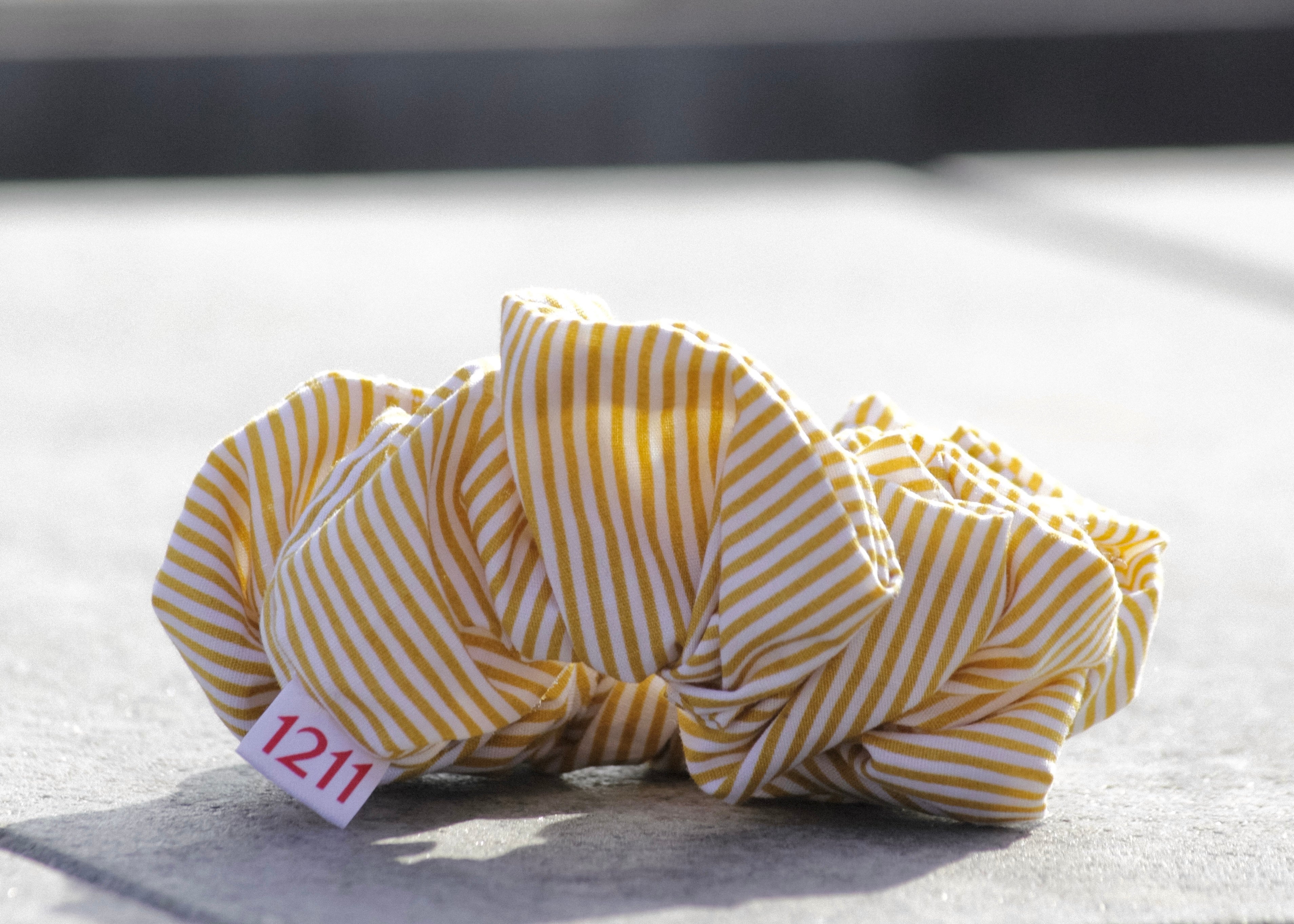 Yellow scrunchie with white stripes, elegant hair accessory from Twelveeleven, perfect for everyday styling.